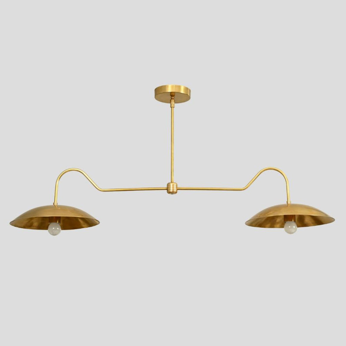 Overhead view of brass double dome chandelier – minimalist modern pendant light with curved arms and dual dome shades