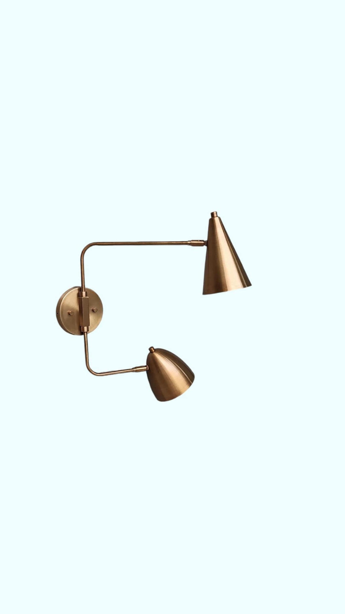 Minimalist handmade brass double shade wall sconce – straight-on view