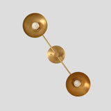 Close angled view of brass double wall sconce with two elegant bowl shades, handcrafted solid brass modern wall light fixture.