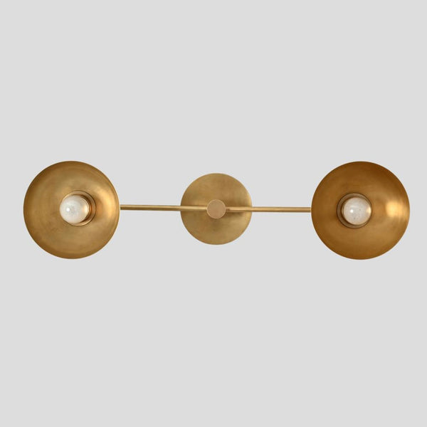 Handmade brass double wall sconce with two bowl shades and central mount, modern industrial wall light by Brass Leaf Studio.