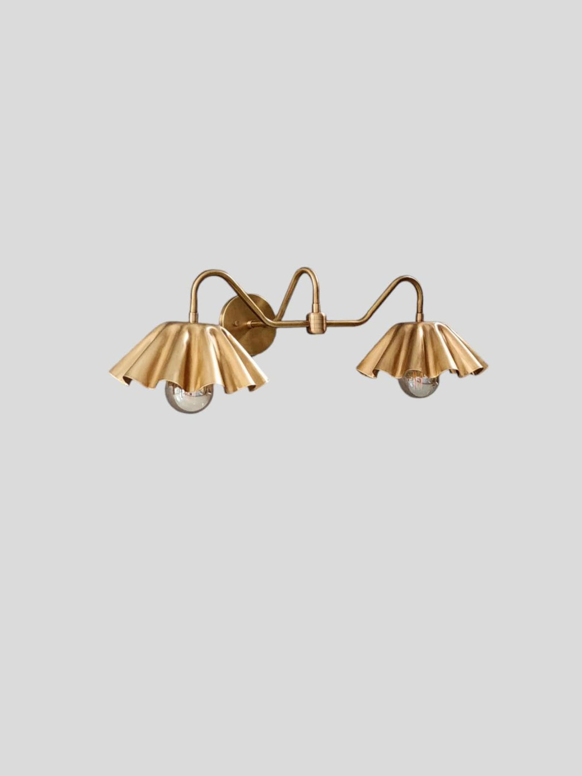 Custom brass wall sconce with two ruffled shades – side angle