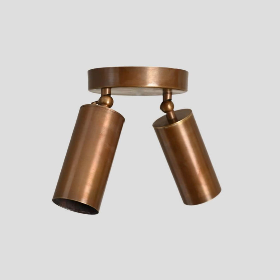 Handmade brass dual-cylinder flush mount ceiling light, modern minimalist design with adjustable cylindrical shades close-up view