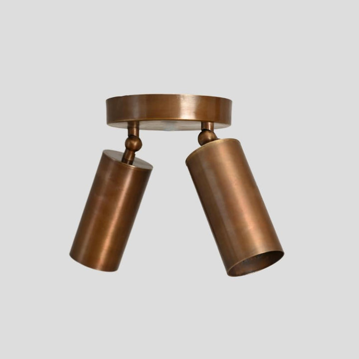 Brass dual-cylinder ceiling light fixture, modern minimalist flush mount lighting angled side view
