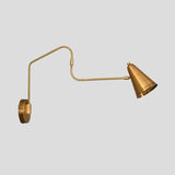 Extended brass swing arm wall sconce with cone shade, adjustable minimalist wall light design