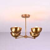 Modern brass flushmount chandelier with brushed finish and four symmetrical bowl shades