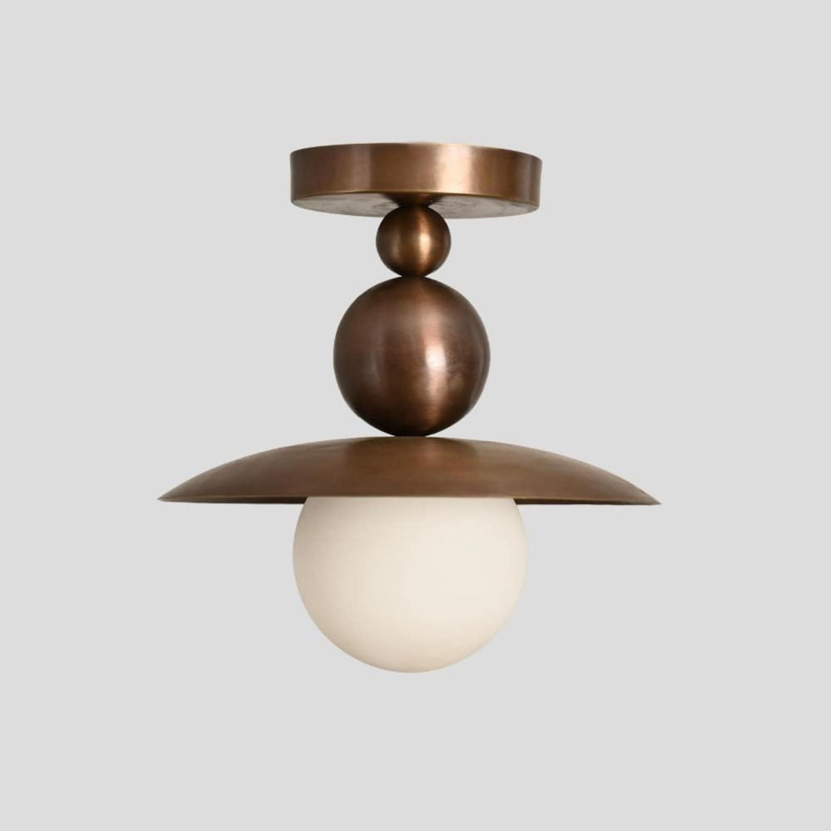Modern flushmount brass ceiling light featuring layered dome shade and opal globe bulb, handcrafted for minimalist and contemporary interiors.