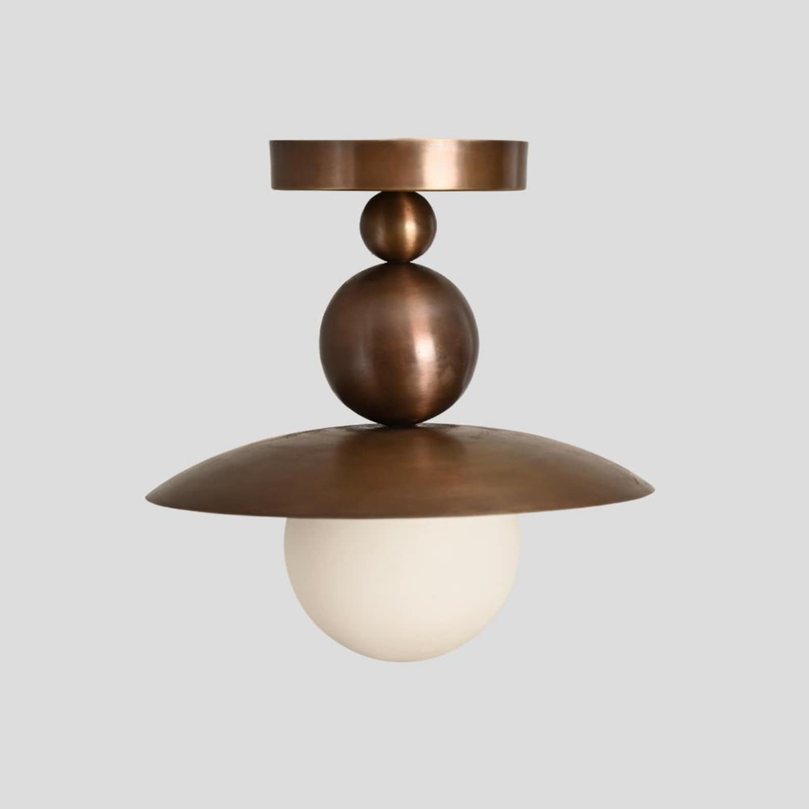 Customizable brass flushmount chandelier with sculpted dome and glowing globe shade, handmade by Brass Leaf Studio for stylish home or commercial use.