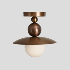 Customizable brass flushmount chandelier with sculpted dome and glowing globe shade, handmade by Brass Leaf Studio for stylish home or commercial use.