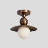 Vintage-inspired brass flushmount ceiling light with ribbed dome detail and globe diffuser, blending industrial durability with elegant modern design.