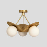 Handmade brass ceiling chandelier with three frosted globes and ribbed fluted brass disc shades, designed for modern interiors.