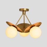 Elegant flushmount chandelier in solid brass with three frosted globes and sculpted fluted disc shades, handmade lighting by Brass Leaf Studio