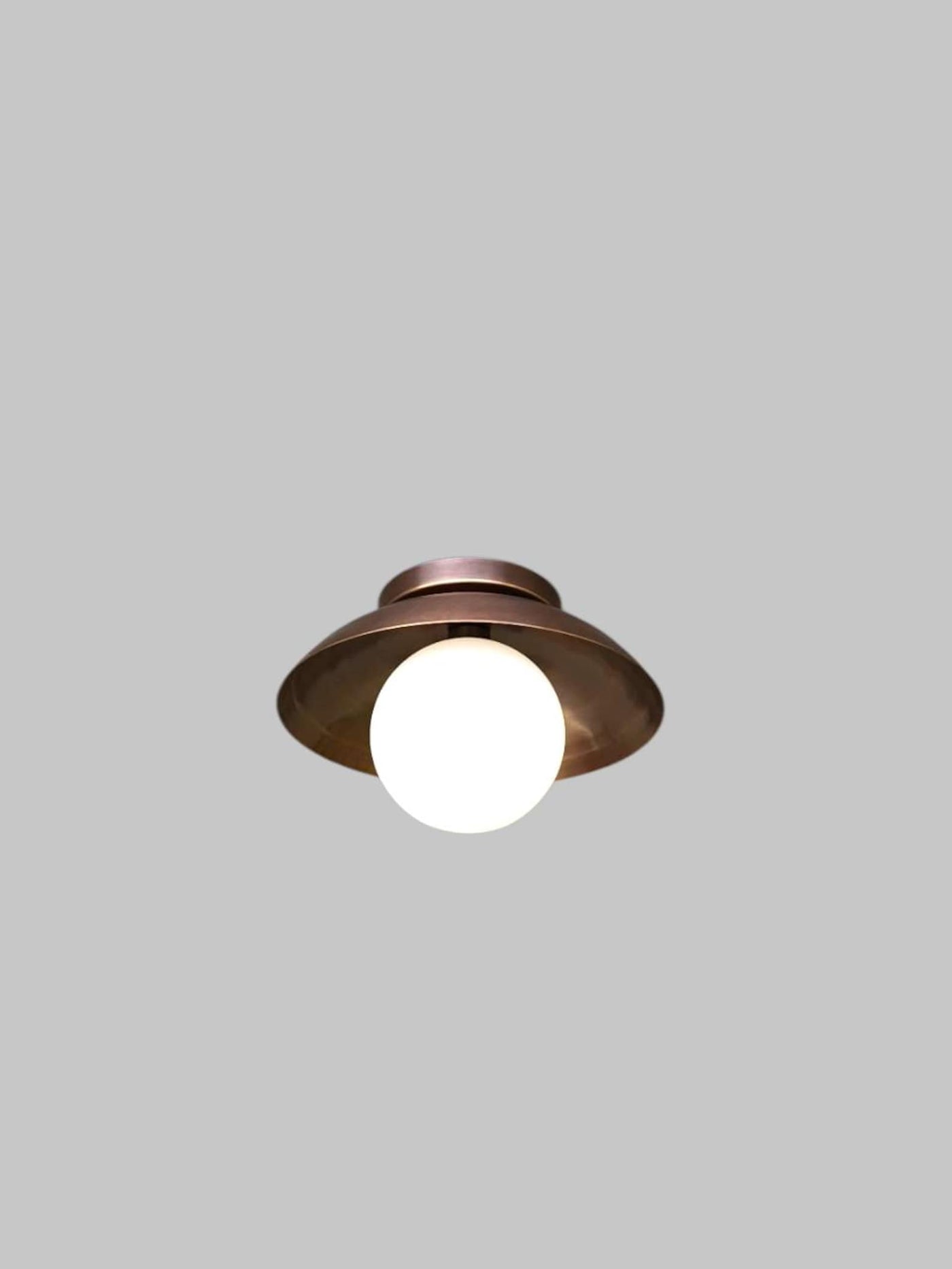 Elegant brass flush mount ceiling light with frosted glass globe, front view