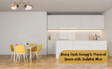 Brass ceiling light installed in a minimalist kitchen with white cabinets and yellow dining chairs