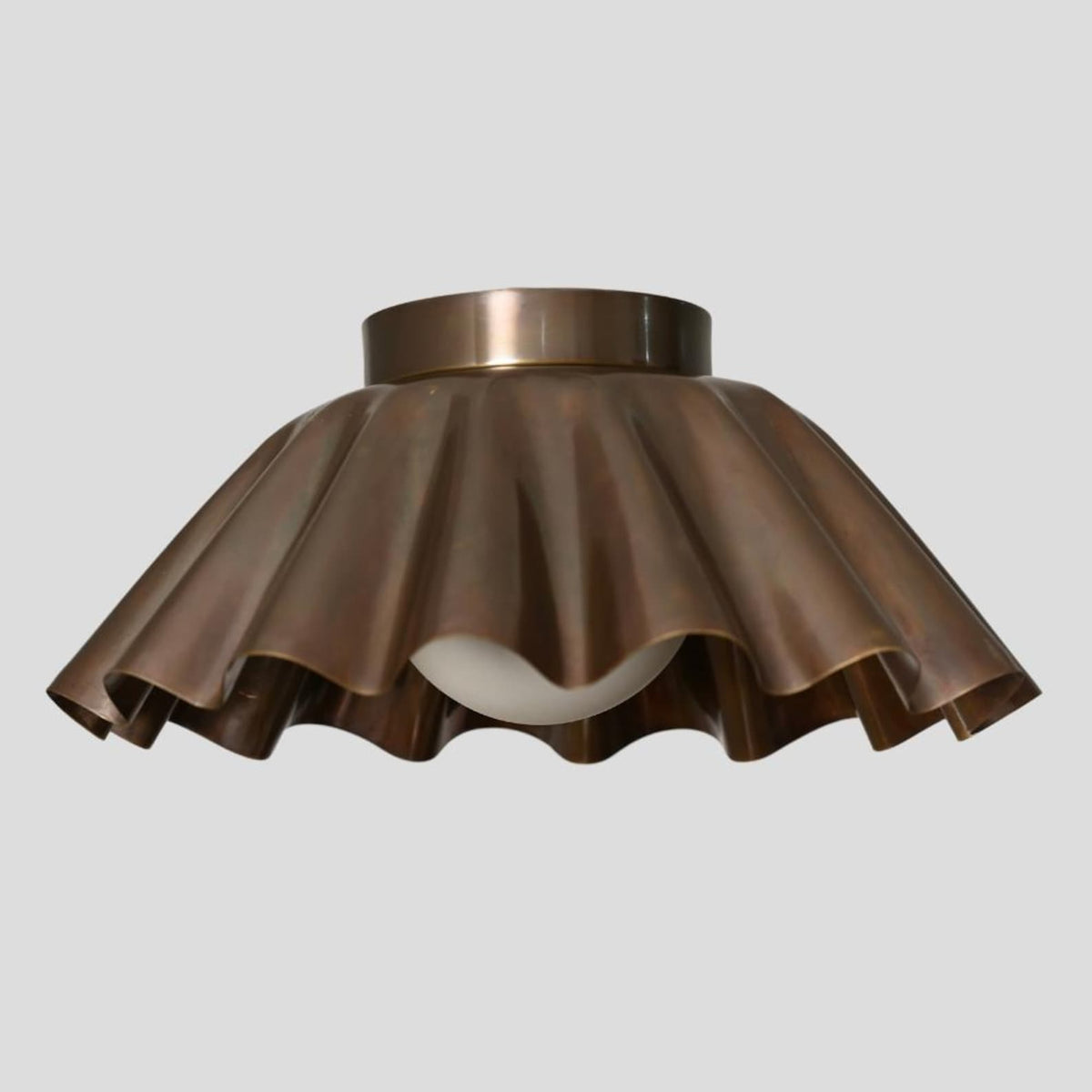 Customizable brass flush mount ceiling light with wavy sculpted shade design for living rooms, dining areas, and boutiques.