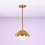 Minimalist brass fluted pendant light hanging straight with sculpted shade and glowing globe.
