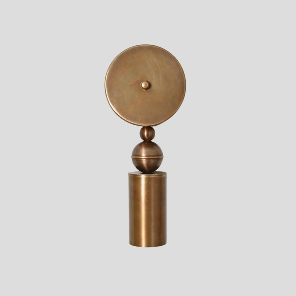 Handmade sculptural brass wall sconce with cylindrical base and spherical element, modern artistic wall lighting