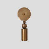 Handmade sculptural brass wall sconce with cylindrical base and spherical element, modern artistic wall lighting