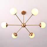 Top-down view of 6-light brass globe chandelier showing balanced radial arm layout and frosted globes.