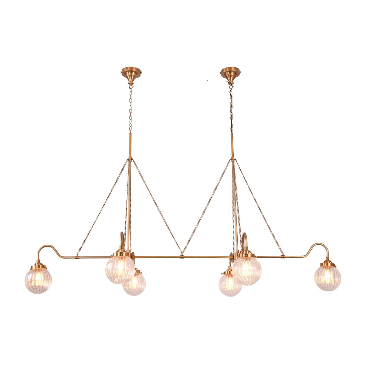Brass linear chandelier with six glowing ribbed glass globes creating warm ambient light for modern luxury spaces