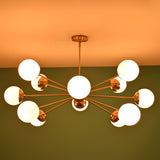 Brass chandelier with glowing glass globes in a modern interior setting