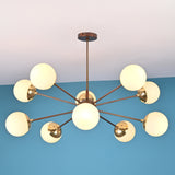 Symmetrical modern brass chandelier with opal globe shades arranged in a sculptural radial pattern.