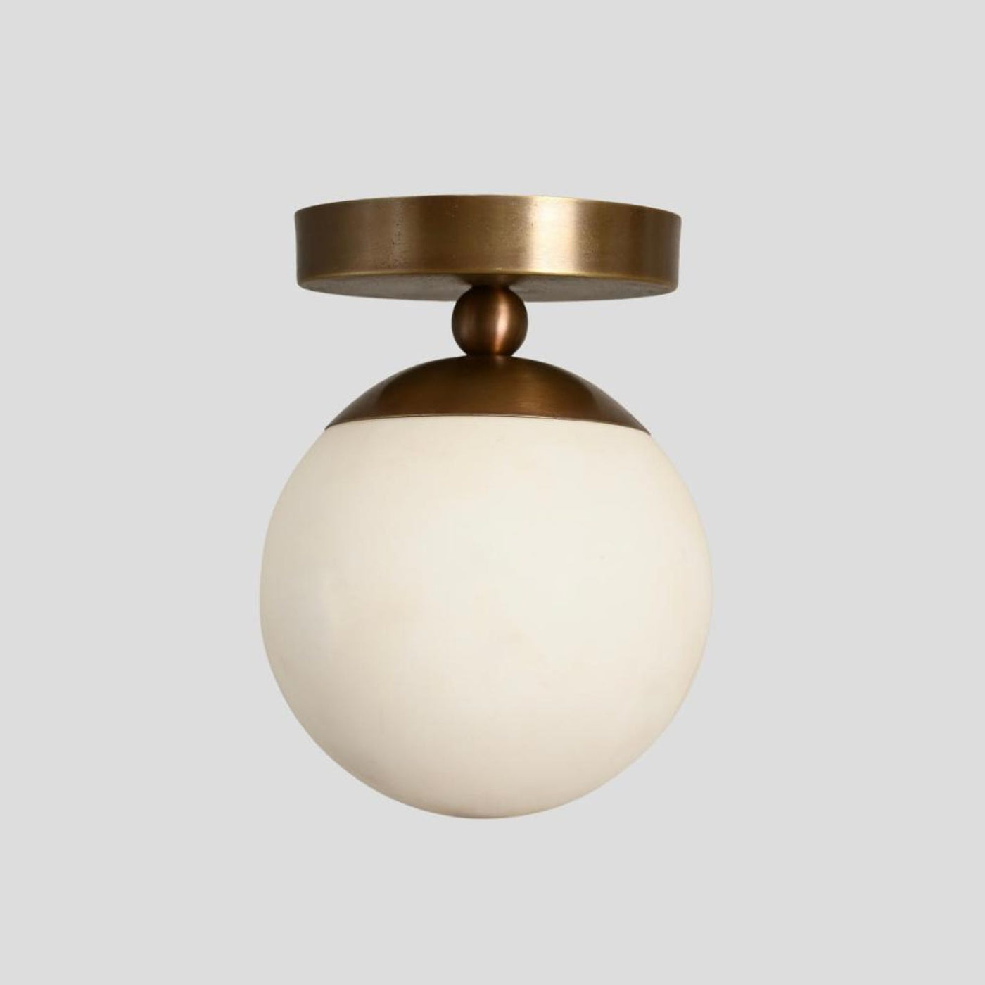 Handmade brass flush mount ceiling light with opal glass globe – modern minimalist design by Brass Leaf Studio