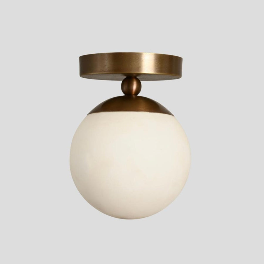 Handmade brass flush mount ceiling light with opal glass globe – modern minimalist design by Brass Leaf Studio