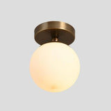 Brushed brass flush mount ceiling light with round opal globe – elegant handmade lighting for entryways and dining areas