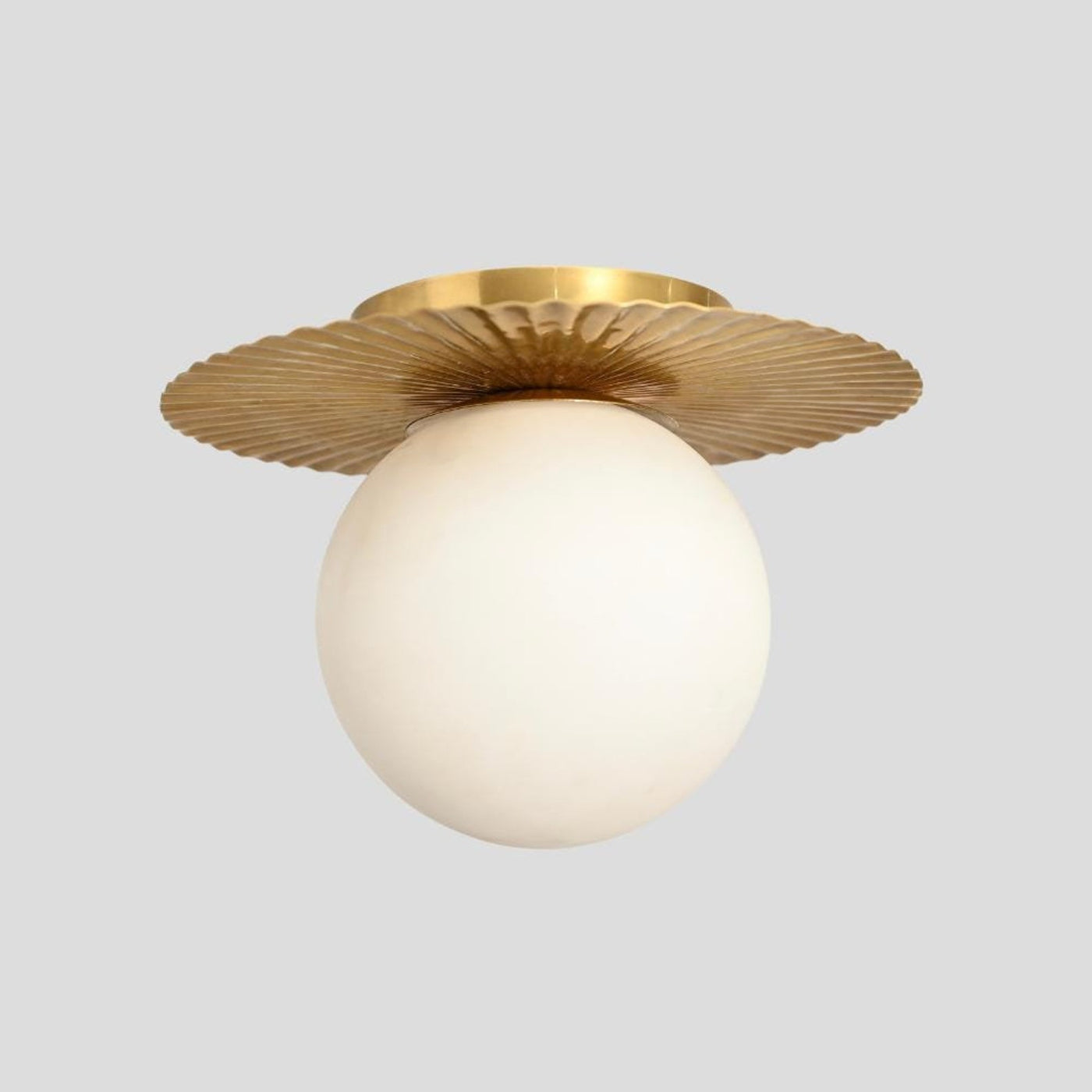 Handmade brass flush mount ceiling light with frosted globe shade and fluted brass base