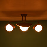 Wide view of 4 light brass flush mount ceiling fixture creating ambient lighting across the ceiling