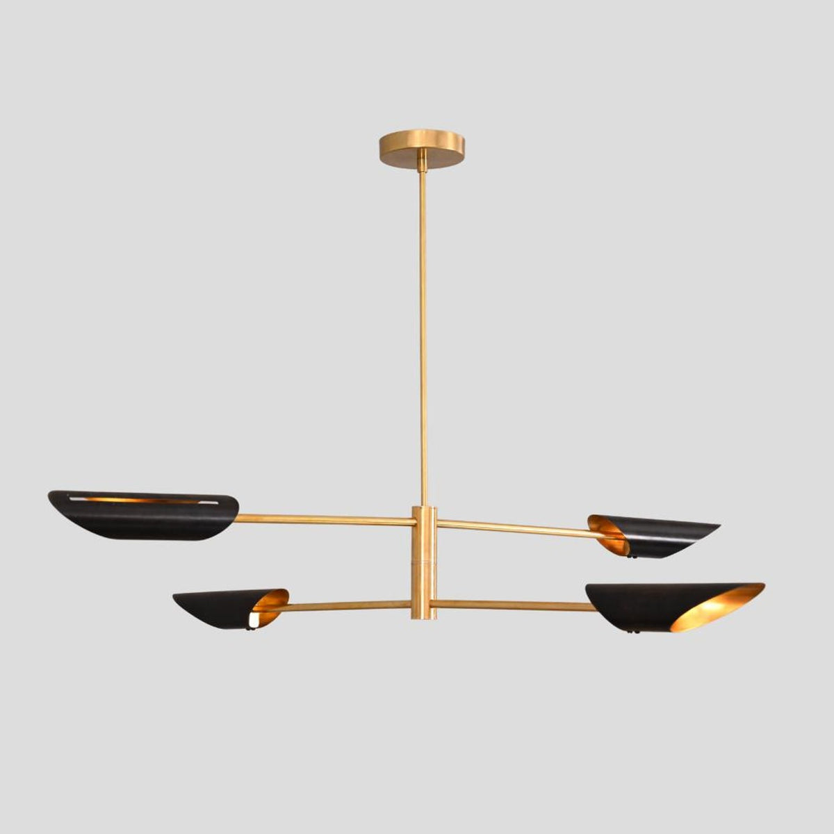 Handmade brass chandelier with three bowl-shaped black shades, sleek pendant light for dining areas, offices, and entryways.