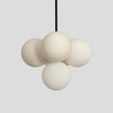 Contemporary brass chandelier with clustered frosted glass globes for modern interiors – Brass Leaf Studio