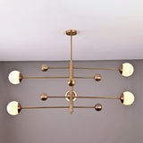 Brass Leaf Studio Aurelia globe chandelier featuring a 5 light linear design with solid brass construction and opal glass shades