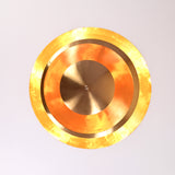 Top view of handcrafted brass chandelier showing concentric circular design and polished glow