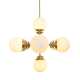 Overhead view of glowing brass linear chandelier with frosted glass globes – artisan modern lighting by Brass Leaf Studio