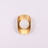 Brass Leaf Studio crescent wall light with opal globe and warm decorative wall illumination