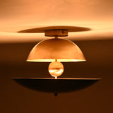 Night view of a dome and bowl chandelier showing warm ambient illumination and dramatic upward and downward glow patterns.