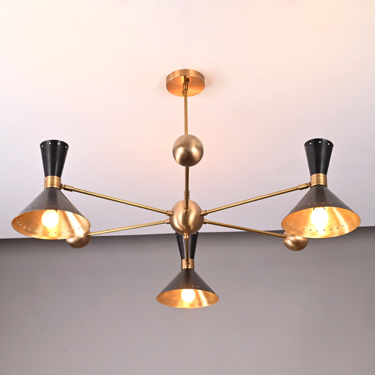 Industrial-style 3-light brass ceiling light featuring cone shades and brushed brass finish by Brass Leaf Studio.