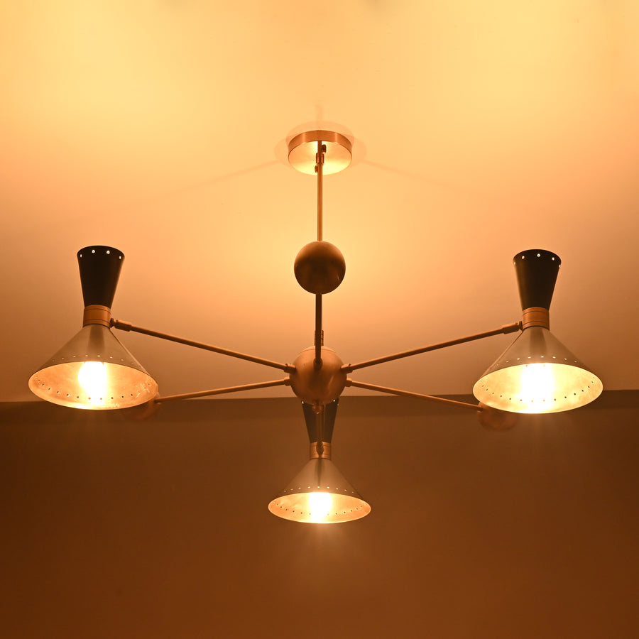 Modern 3-light brass chandelier with black cone shades and industrial arms, handcrafted by Brass Leaf Studio.