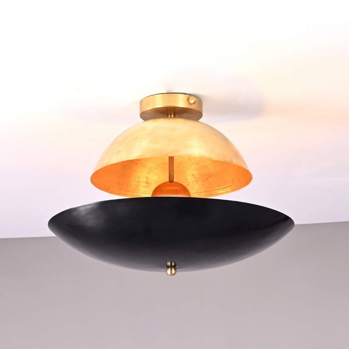 Modern brass ceiling light with an upper brushed brass dome and lower matte black bowl shade, handcrafted by Brass Leaf Studio.