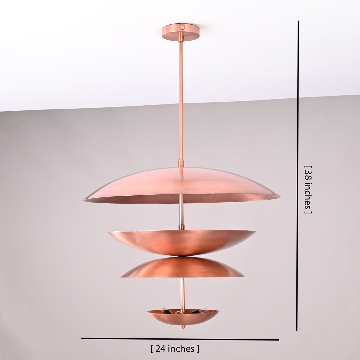 Front view of a handmade multi-tier brass chandelier, 24-inch width and 38-inch height, featuring layered bowl-shaped shades by Brass Leaf Studio.
