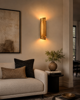 Brass Leaf Studio ribbon wall sconce with layered curved brass design and ambient wall wash