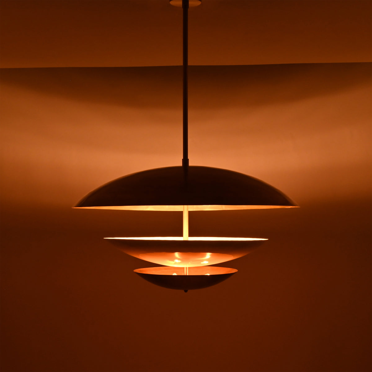 Brass Leaf Studio tiered pendant light with layered circular shades, white diffuser, and premium ceiling light design