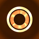 Glowing top view of a circular tiered disc light with bright illuminated rings and handcrafted metallic finish.