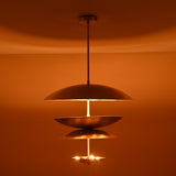 Warm ambient glow from triple bowl brass chandelier with brushed finish, handcrafted by Brass Leaf Studio