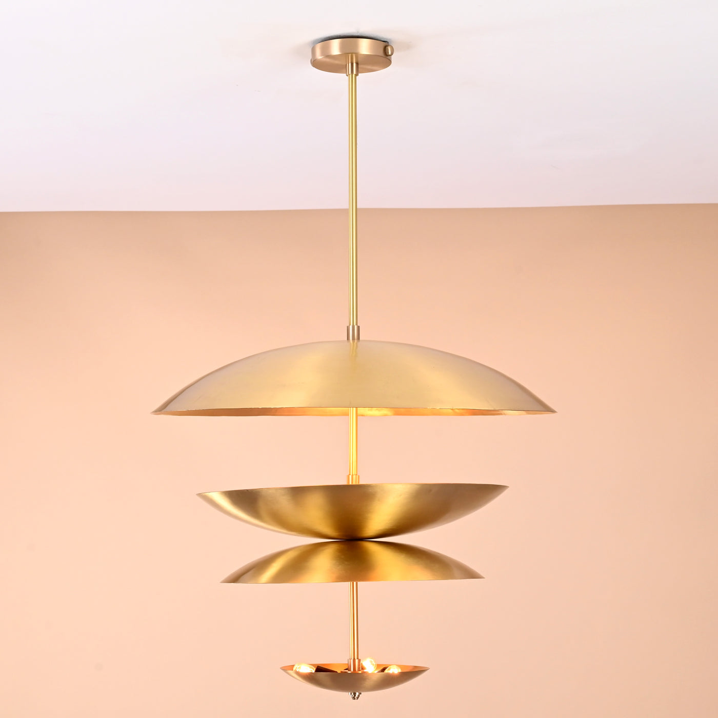 Handcrafted triple bowl brass pendant light with minimalist sculpted design in brushed lacquer finish