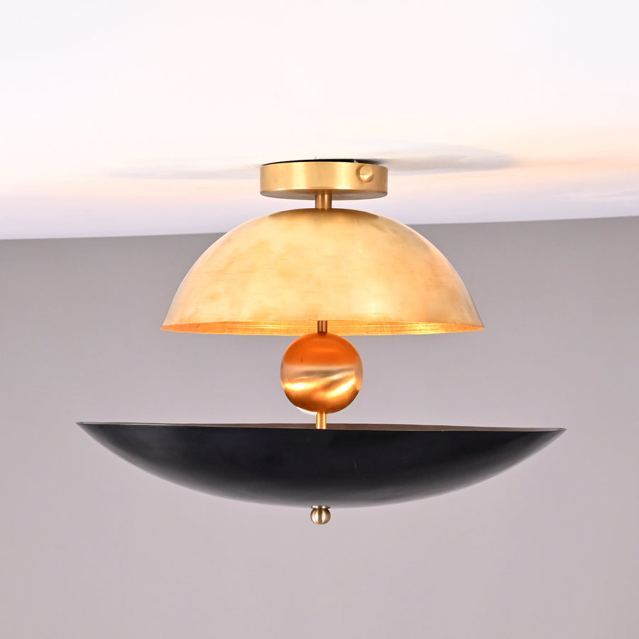 Two-tone dome and bowl flushmount chandelier featuring brushed brass and matte black shades with a sculptural brass sphere centerpiece.