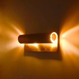Brass Patina bedside wall light with minimal cylinder design and soft relaxing glow