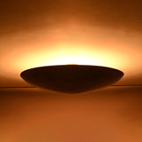 Brass patina halo ceiling light casting soft upward glow across the ceiling surface