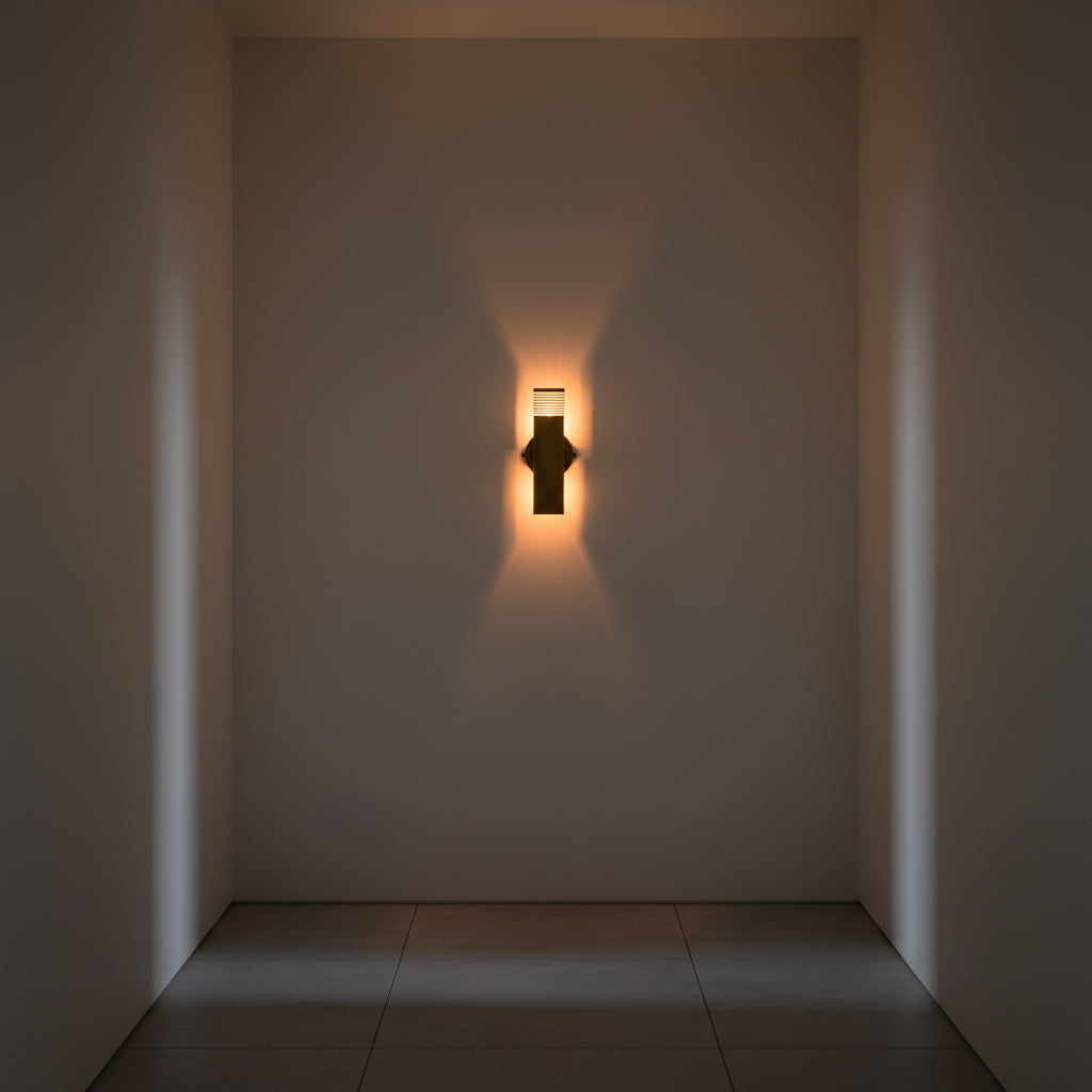 Brass patina rectangular wall light with slim vertical tube design and warm ambient illumination for hallway or bedroom walls